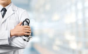 Doctor holding stethoscope | IntraOffice | TeleMed Inc.