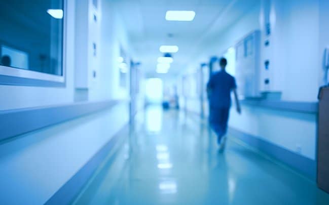 Nurse walking down hospital hallway | MyService | TeleMed Inc.
