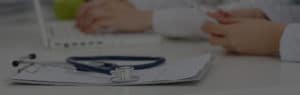 Clipboard and stethoscope on doctor's desk | TeleMed Inc.